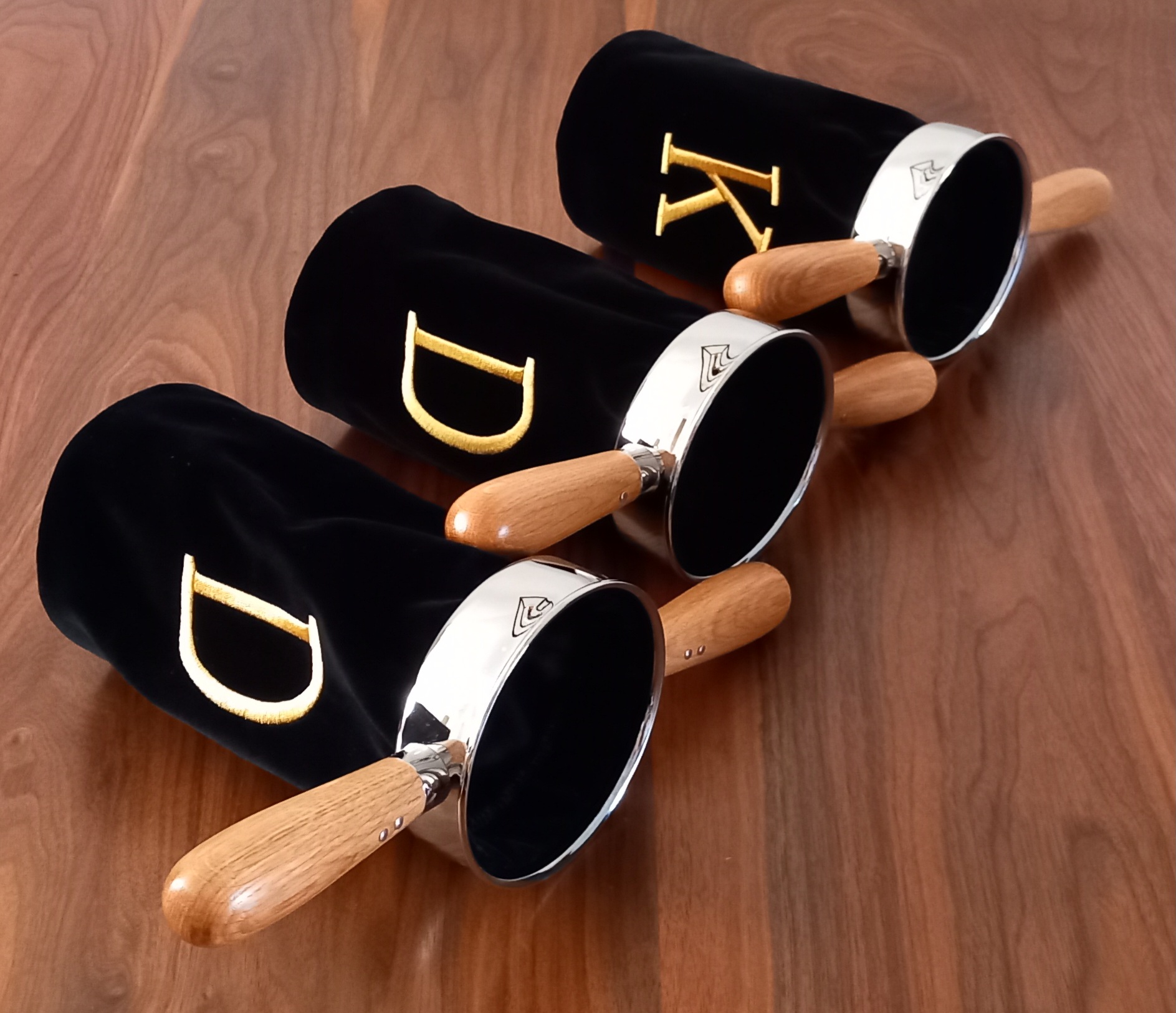 Zwarte collectezak houders met twee beuken houten handgrepen.